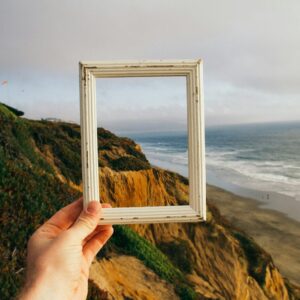 person hand holding photo frame